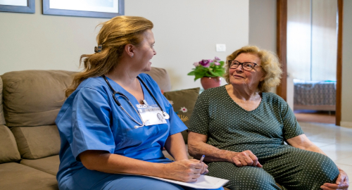 Nurse consulting a patient at a care home
