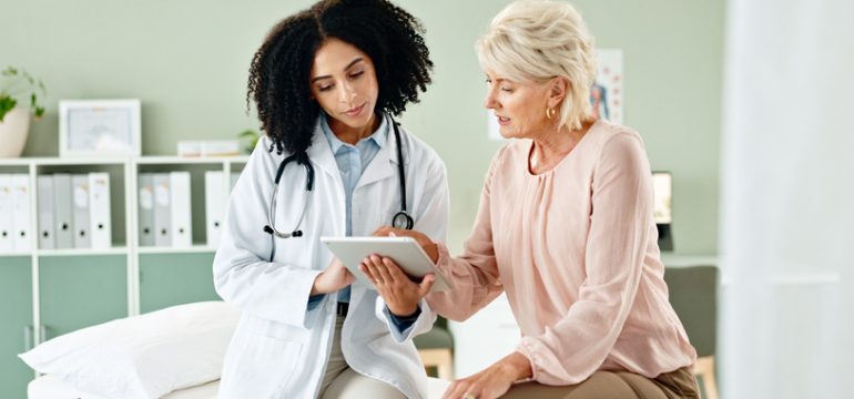 patient consulting with a doctor in a GP clinic