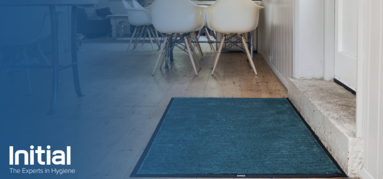Initial floor mat pictured with initial logo on screen