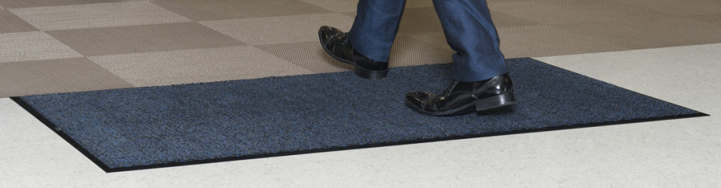 entrance floor mat placed at a building doorway to trap dirt and moisture