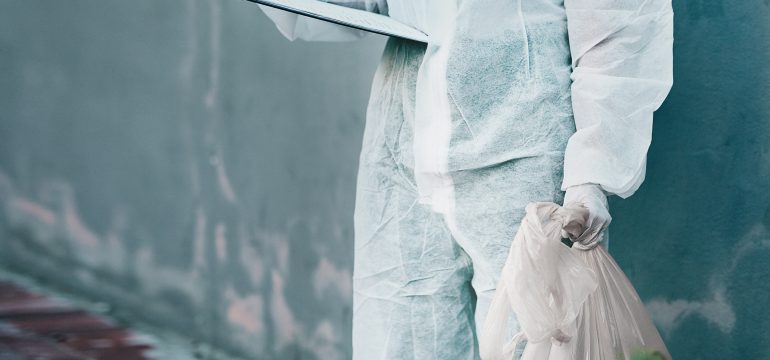 An Initial Medical employee disposing clinical waste
