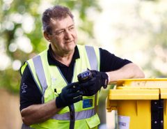 Technician with Initial medical wheelie bin