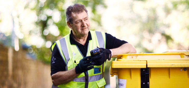 Technician with Initial medical wheelie bin