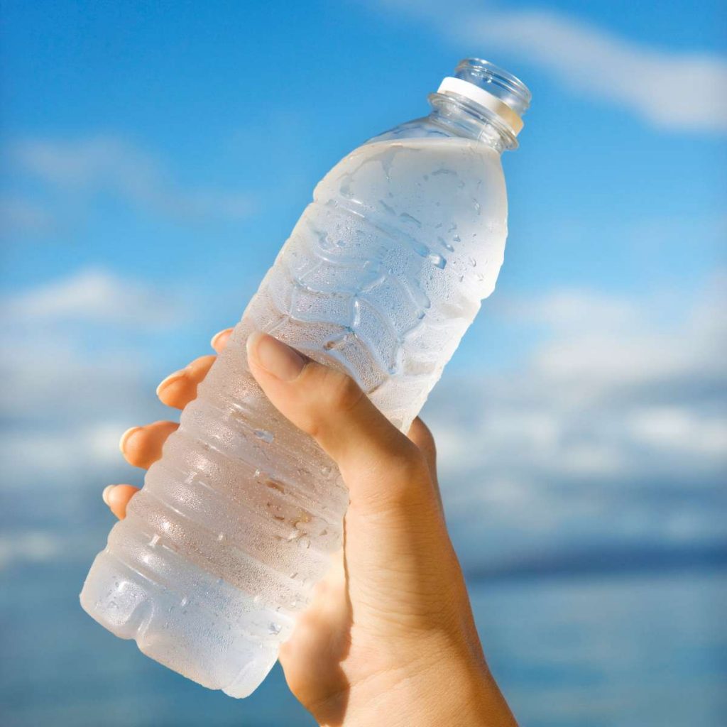 Image showing someone holding an open bottle of water