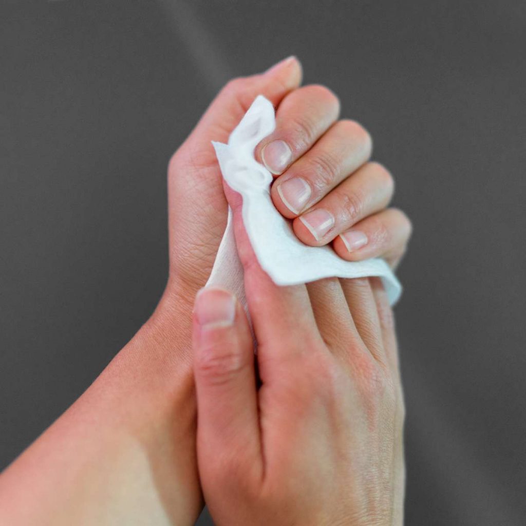 Image showing person using antibacterial hand wipes to clean their hands